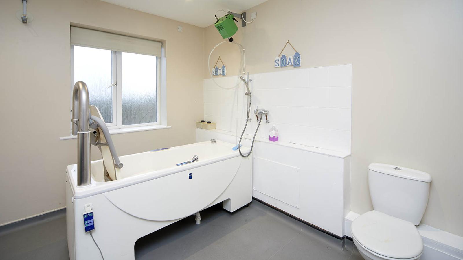 Accessible bathroom with bath and toilet
