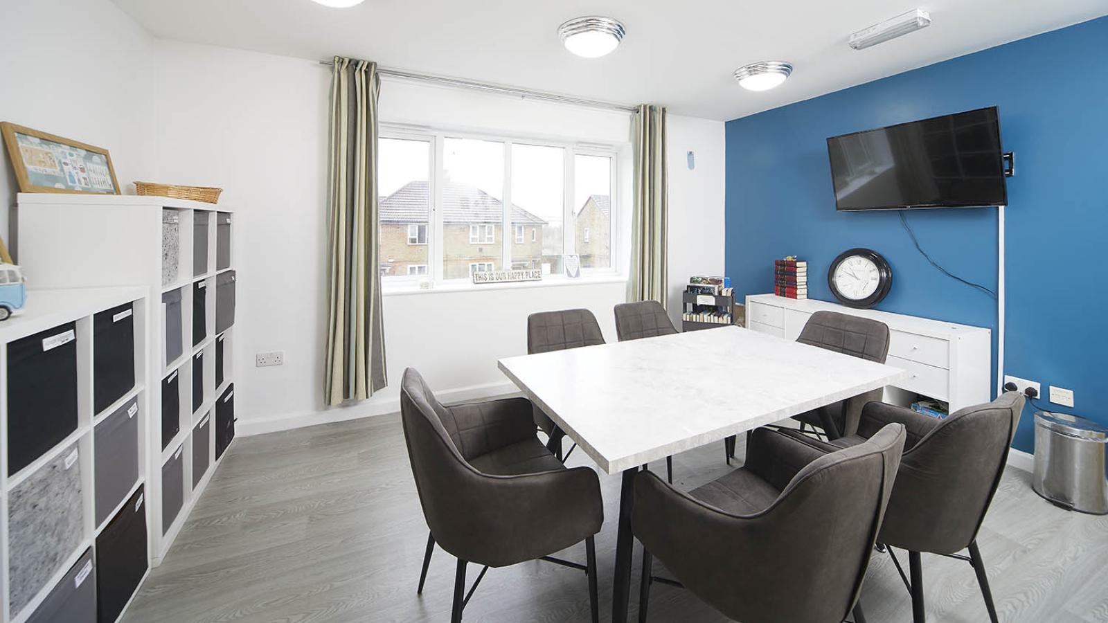 Activities area with table, chairs and TV