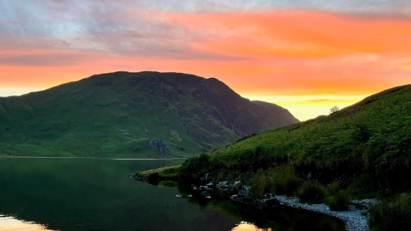 Sunset behind some mountains on a lake