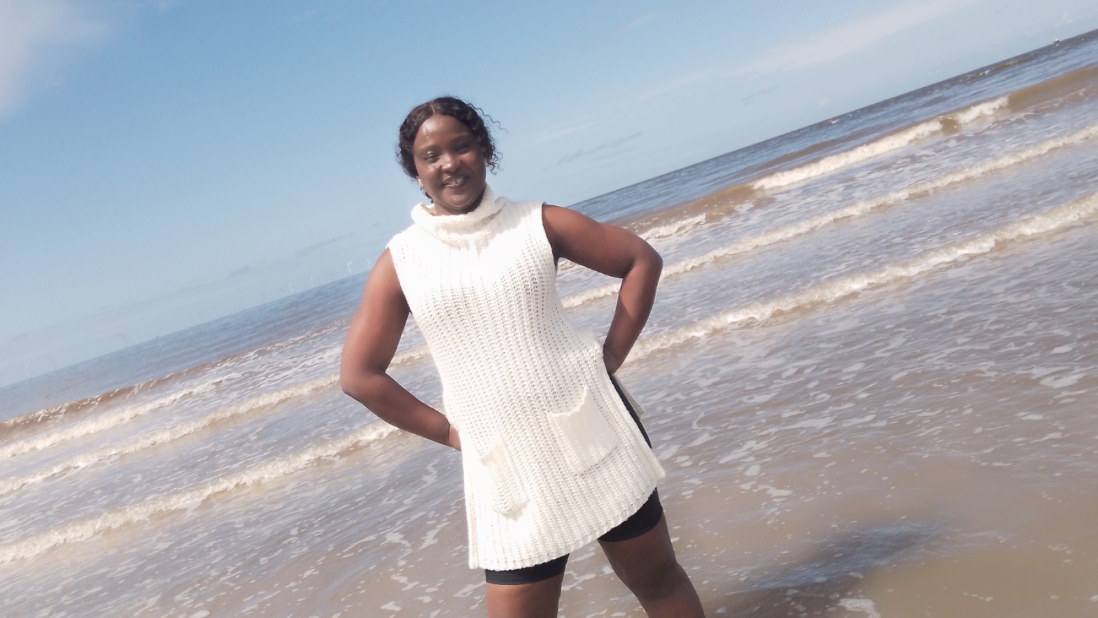 A person stood in the sea at the beach