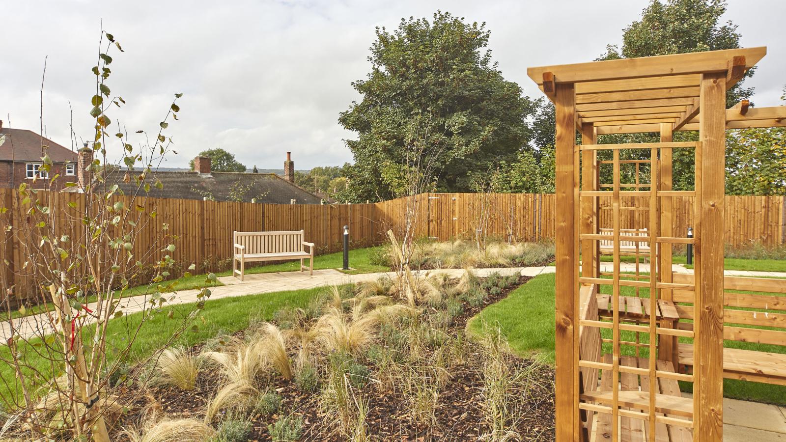 Garden area with benches and wooden seating area