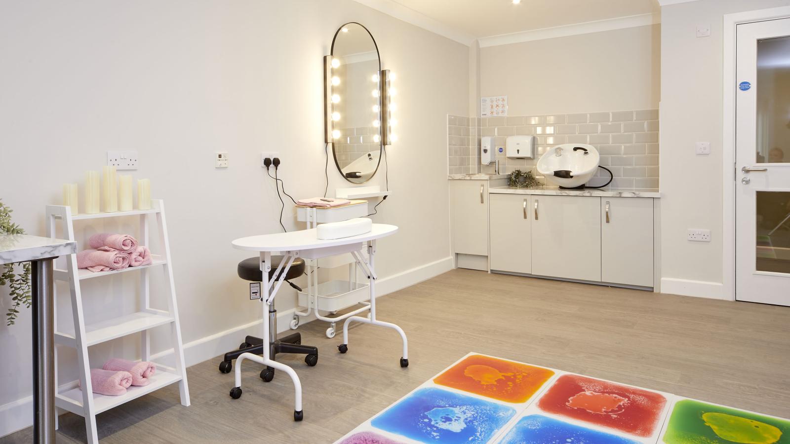 Therapy room with sensory mats, nail bar and hair wash station