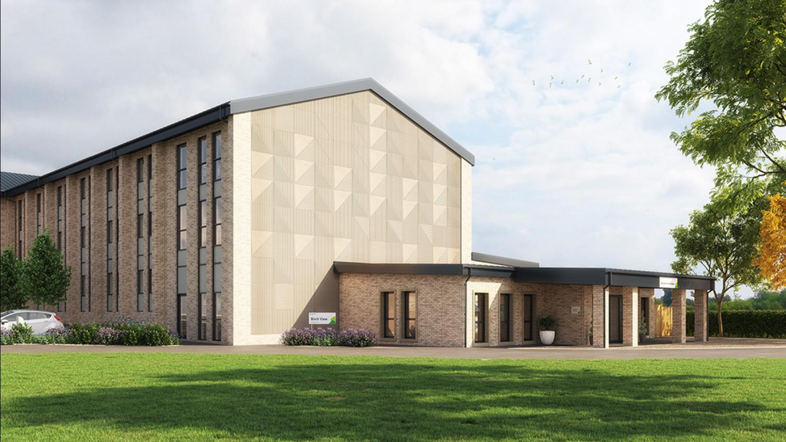 Image of the exterior of a three storey care home with a light beige brickwork. There is a white car in the car park and the building is surrounded by landscaping, trees and a blue sky.