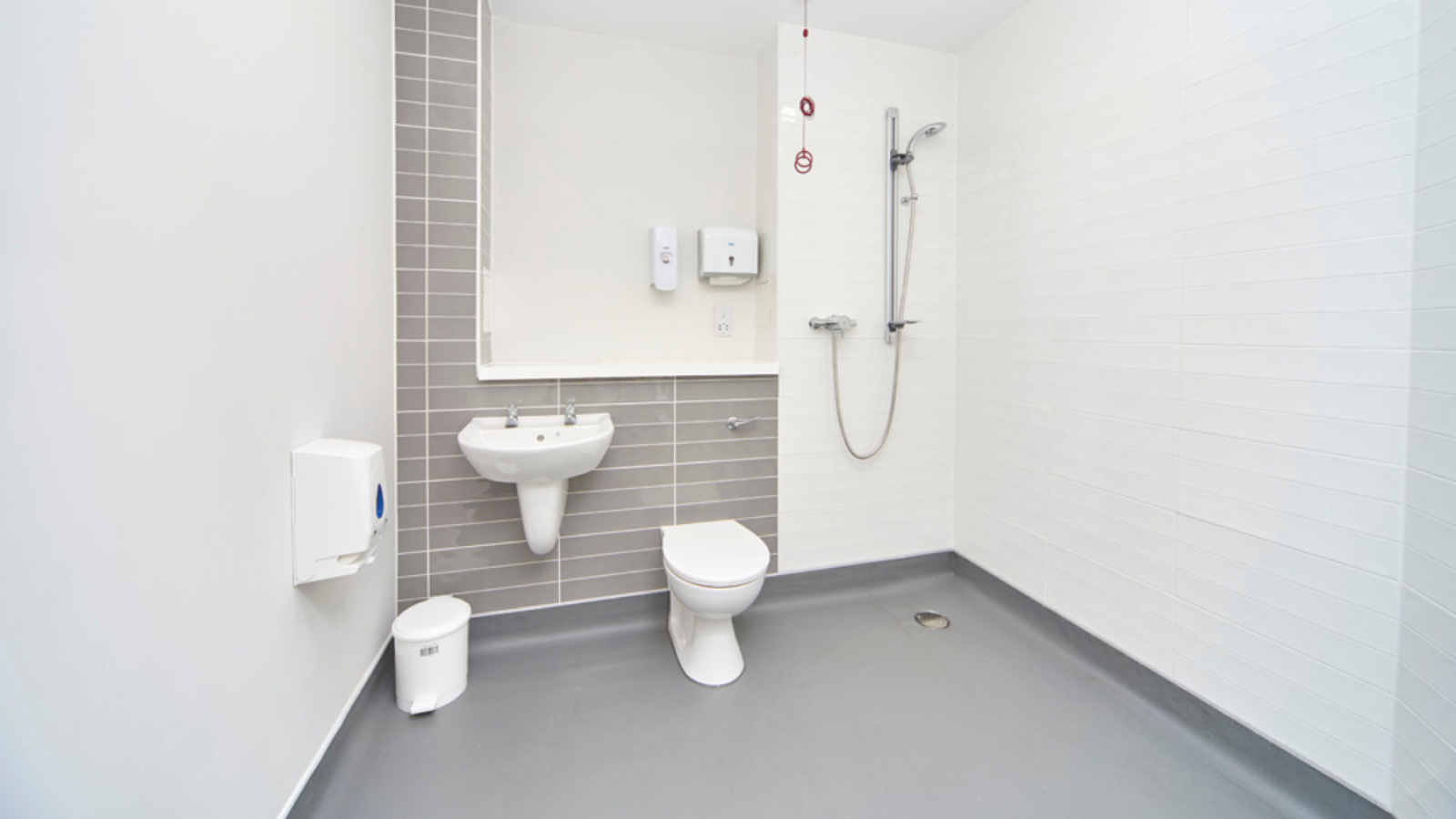 A photo of an en-suite with a shower, toilet and sink