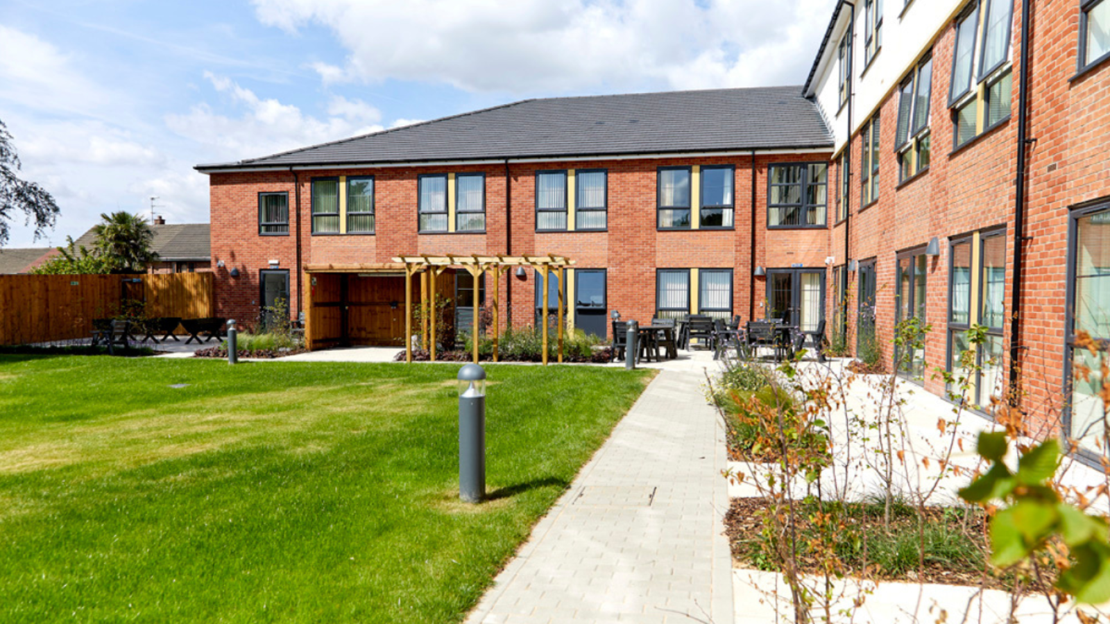 Three storey care home and a large garden with patio