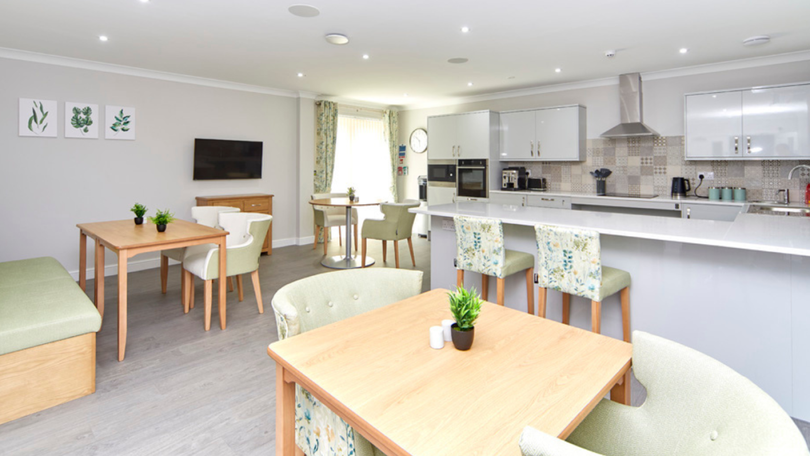 A kitchen/dining area with different tables, chairs and stools