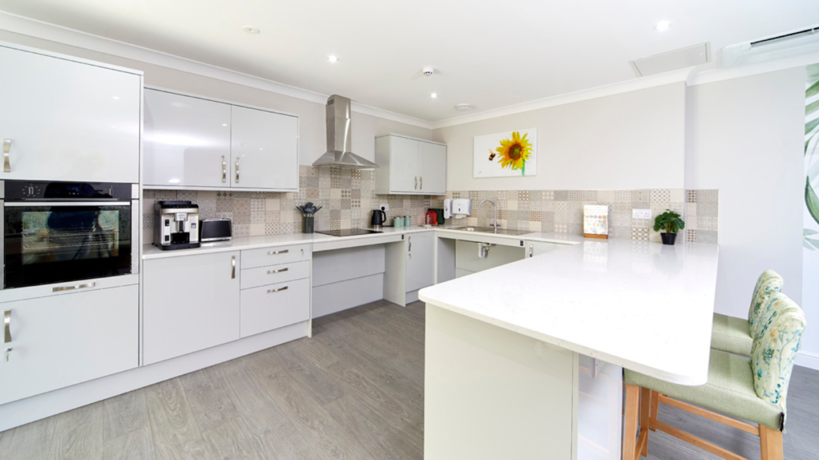 A kitchen/dining area with bar table and stool chairs