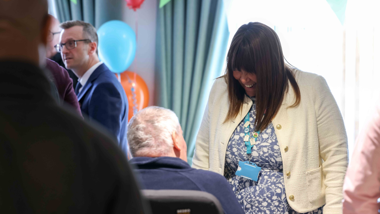 A woman talks to someone in a wheelchair