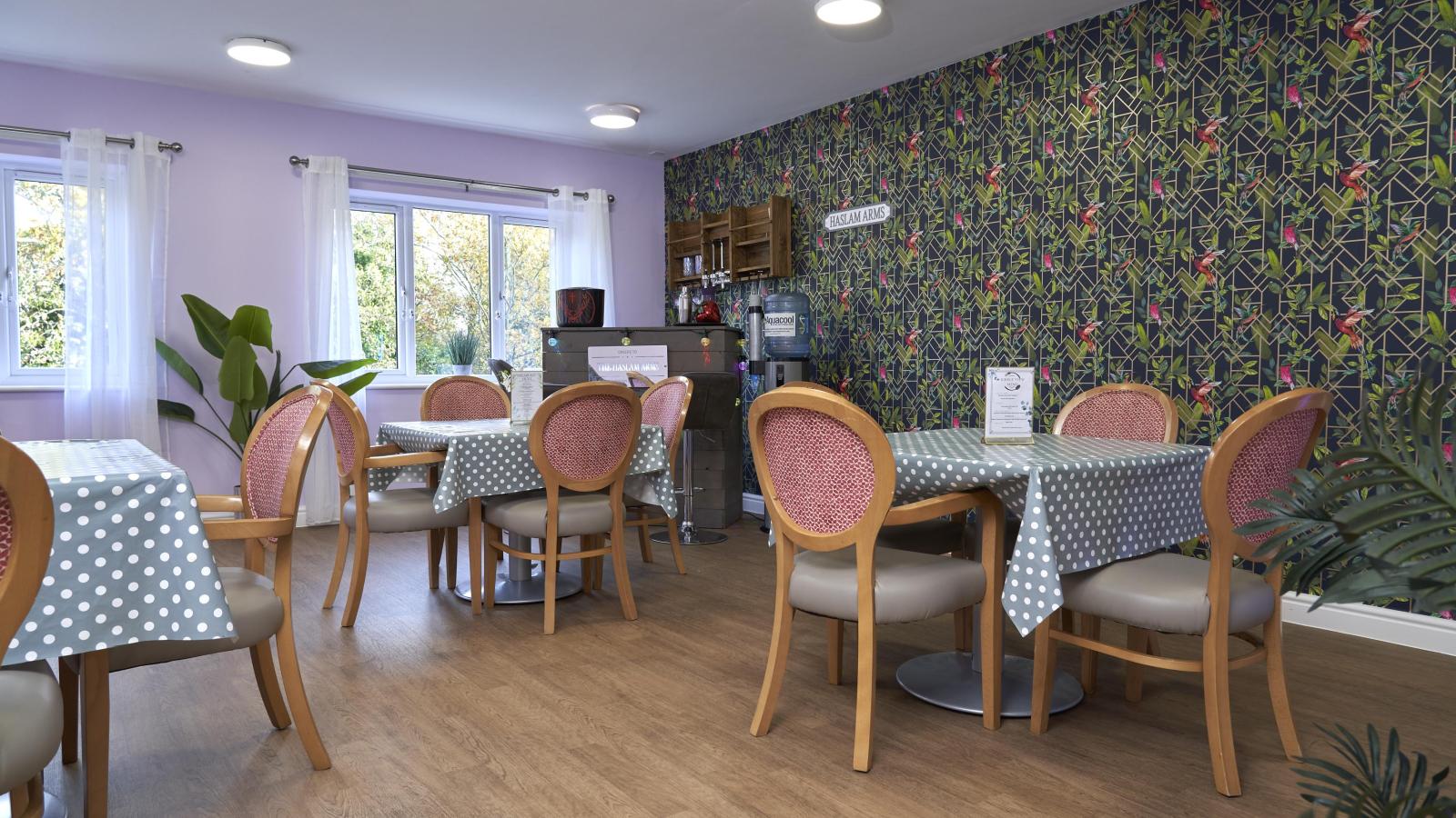 Dining room with two tables set up and a bar in the corner