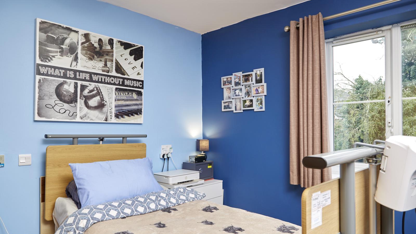Bedroom setting with blue walls and a single bed