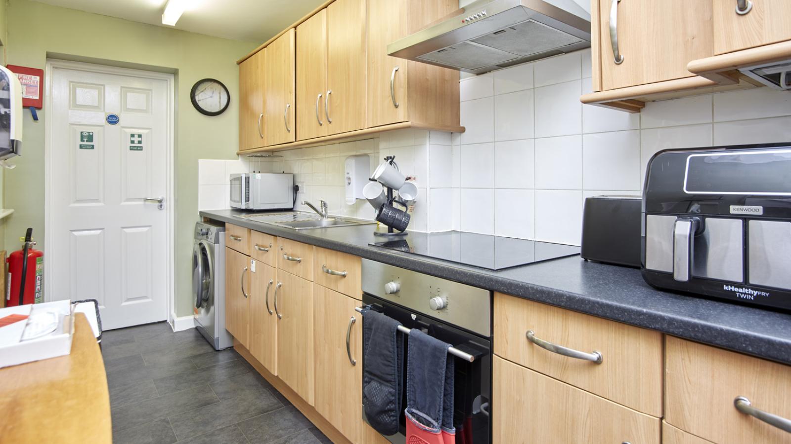 Kitchen space with cupboards and oven