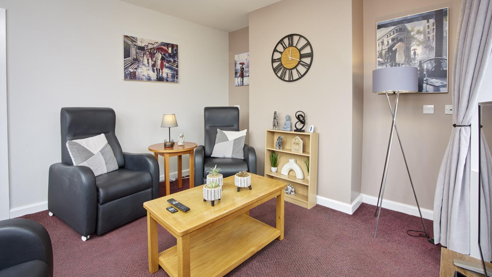 Lounge in a house with two chairs and coffee table