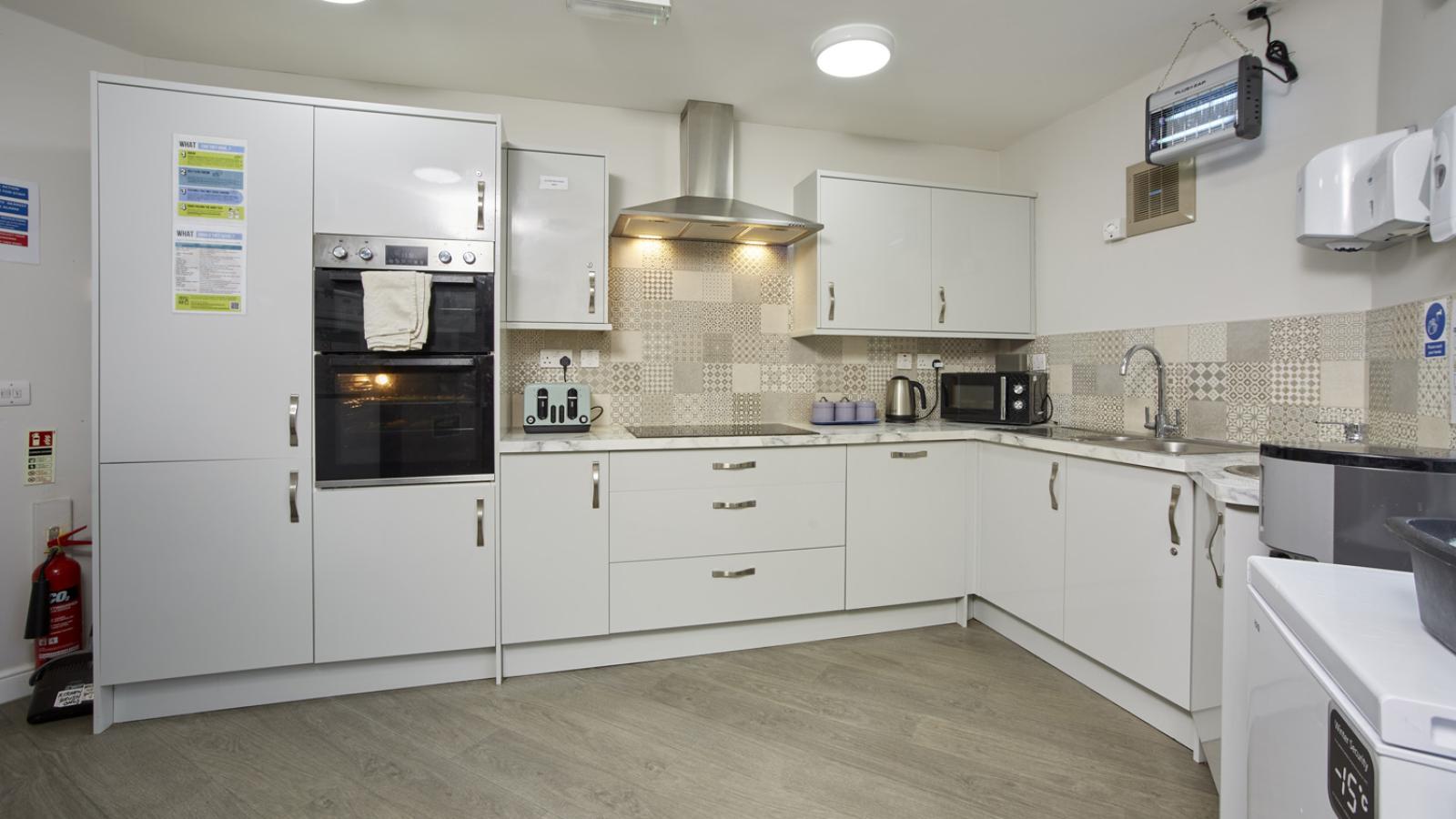 Kitchen with cabinets, oven and equipment