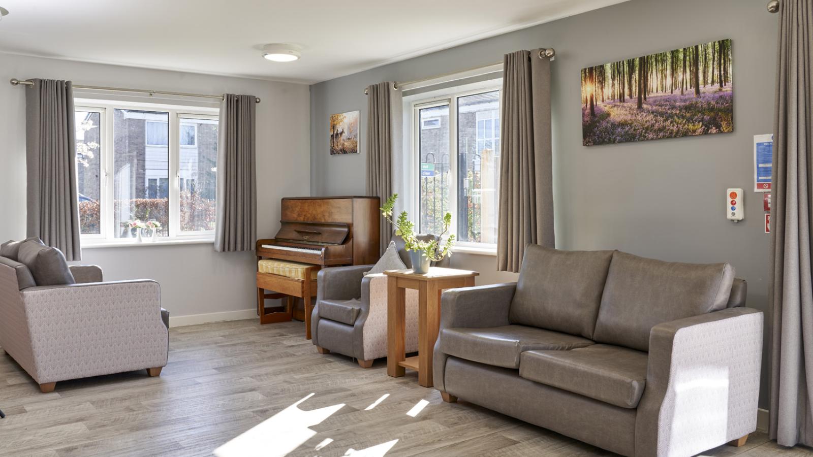 Lounge setting with sofas and chairs, and a large piano in the corner