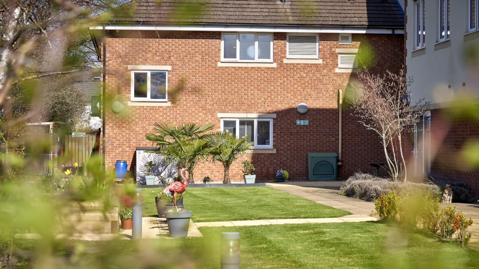 Garden setting with green lawn and range of trees and plants surrounding