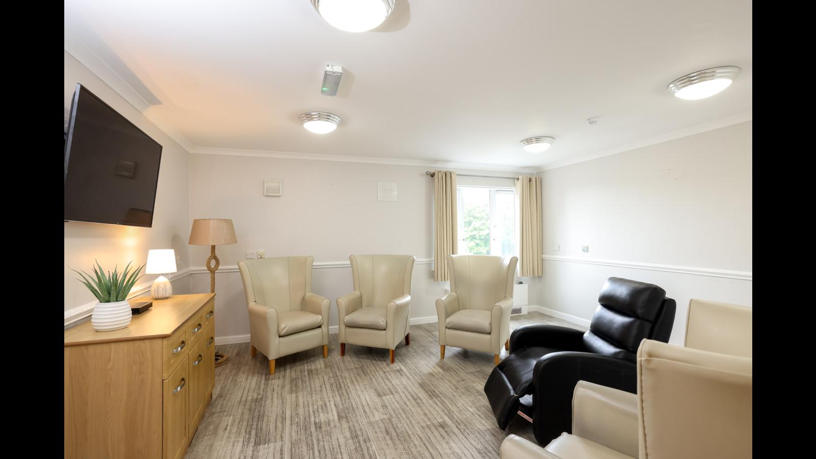 Lounge set up with comfy chairs and TV