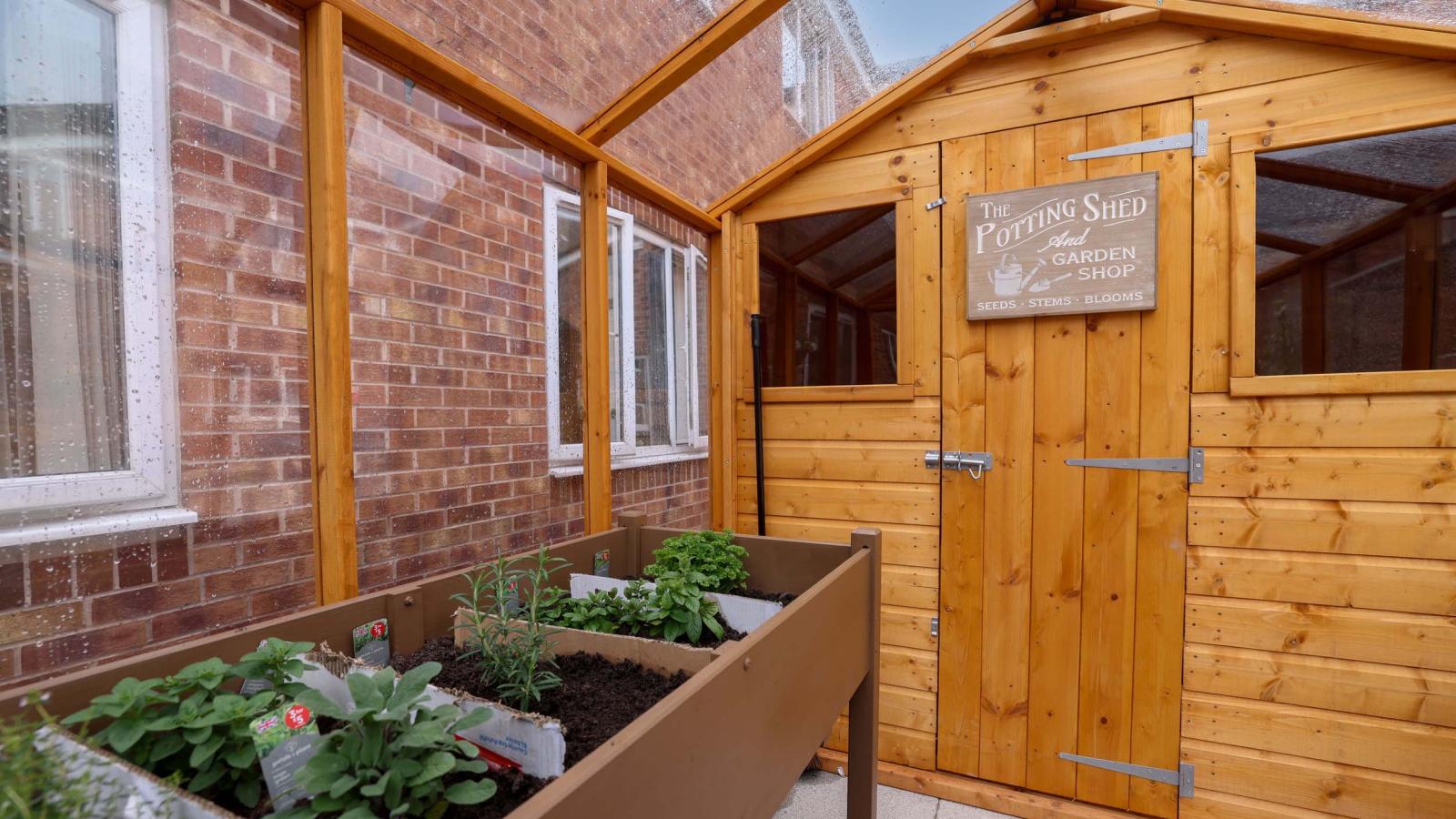 Outdoor garden shed with a planter in the foreground